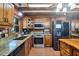 Well-lit kitchen with modern appliances, wooden cabinets, and granite countertops at 1550 Bayshore Dr, Englewood, FL 34223