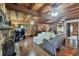 Comfortable living room with stone fireplace, wood floors, staircase, and lots of natural light at 1550 Bayshore Dr, Englewood, FL 34223