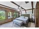 Comfortable main bedroom with vaulted ceilings, exposed wood beams, and views of the outside at 1550 Bayshore Dr, Englewood, FL 34223
