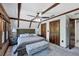 Well-lit main bedroom with vaulted ceilings, exposed wood beams, and an ensuite bathroom at 1550 Bayshore Dr, Englewood, FL 34223