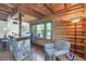 Cozy log cabin home office area with stone accents and natural light at 1550 Bayshore Dr, Englewood, FL 34223