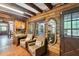Cozy sitting area with wooden desk, seating, and charming log cabin details at 1550 Bayshore Dr, Englewood, FL 34223