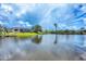 Waterfront property with lush backyard, screened lanai, and private dock on a beautiful sunny day at 15610 Staunton Cir, Port Charlotte, FL 33981