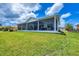 Expansive backyard with a large screened lanai, perfect for outdoor entertaining and relaxation at 15610 Staunton Cir, Port Charlotte, FL 33981