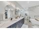 Luxurious bathroom with double vanities, a soaking tub, and modern finishes at 15610 Staunton Cir, Port Charlotte, FL 33981