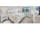 Bright bedroom features a queen-sized bed, neutral decor, and a window with a picturesque view at 15610 Staunton Cir, Port Charlotte, FL 33981