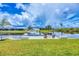 Scenic backyard view of a private boat dock on a calm canal, perfect for boating enthusiasts at 15610 Staunton Cir, Port Charlotte, FL 33981