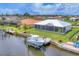 Beautiful waterfront home featuring a boat lift and scenic views of the canal and surrounding neighborhood at 15610 Staunton Cir, Port Charlotte, FL 33981