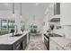 Modern kitchen with dark blue island and white cabinets with stainless steel appliances at 15610 Staunton Cir, Port Charlotte, FL 33981