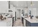 Bright, modern kitchen featuring white cabinets, marble countertops, and stainless steel appliances at 15610 Staunton Cir, Port Charlotte, FL 33981