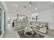 Spacious living room open to kitchen featuring a large sectional sofa at 15610 Staunton Cir, Port Charlotte, FL 33981