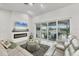 Bright living room with fireplace, TV, comfortable seating, and sliding glass doors to the outdoor space at 15610 Staunton Cir, Port Charlotte, FL 33981