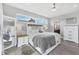 Comfortable main bedroom features large windows, a ceiling fan, and stylish furnishings at 15610 Staunton Cir, Port Charlotte, FL 33981