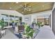Spacious covered patio area with comfortable seating, ceiling fan, and view of the backyard at 15610 Staunton Cir, Port Charlotte, FL 33981