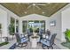 Inviting covered patio with comfortable seating, ceiling fan, and views of the landscaped backyard at 15610 Staunton Cir, Port Charlotte, FL 33981