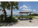 Relaxing picnic area near the water featuring a grill and a shaded shelter for outdoor enjoyment at 15610 Staunton Cir, Port Charlotte, FL 33981