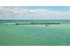 An aerial shot shows a long pier and ocean in the distance at 15610 Staunton Cir, Port Charlotte, FL 33981