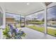 Screened porch with comfortable seating and serene waterfront views of the backyard at 15610 Staunton Cir, Port Charlotte, FL 33981