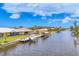 Picturesque waterfront view showcasing backyard with a dock and boat, enhancing waterfront living at 15610 Staunton Cir, Port Charlotte, FL 33981