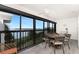 Enclosed balcony with dining table, seating area, and scenic water views at 1591 Beach Rd # 402, Englewood, FL 34223