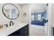 Light filled bathroom features a modern sink and vanity with an open door to the bedroom at 1591 Beach Rd # 402, Englewood, FL 34223