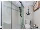 Bright, modern bathroom featuring a glass enclosed shower and marine themed decorations at 1591 Beach Rd # 402, Englewood, FL 34223