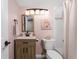 Charming bathroom with a modern vanity, and a combined tub and shower with coral decorations at 1591 Beach Rd # 402, Englewood, FL 34223