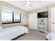 Comfortable bedroom with coastal decor, featuring twin beds, closet, and a large window at 1591 Beach Rd # 402, Englewood, FL 34223