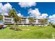 Condo complex with well-maintained green space and mature landscaping at 1591 Beach Rd # 402, Englewood, FL 34223