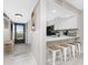 Updated kitchen featuring stainless steel appliances, white cabinets, and breakfast bar at 1591 Beach Rd # 402, Englewood, FL 34223