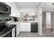 Updated kitchen features stainless steel appliances, white cabinets, and a breakfast bar at 1591 Beach Rd # 402, Englewood, FL 34223