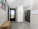 Entryway with a view of the kitchen featuring stainless steel appliances and white cabinets at 1591 Beach Rd # 402, Englewood, FL 34223