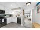 Updated kitchen features stainless steel appliances, white cabinets, and a breakfast bar at 1591 Beach Rd # 402, Englewood, FL 34223