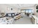 Open living space with couch, armchairs and access to the balcony at 1591 Beach Rd # 402, Englewood, FL 34223