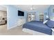 Light-filled main bedroom with blue accent walls and private balcony at 1591 Beach Rd # 402, Englewood, FL 34223