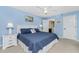Light and airy bedroom with light blue walls and white trim and featuring a king-size bed at 1591 Beach Rd # 402, Englewood, FL 34223