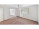 Bright bedroom features a window with vertical blinds and a ceiling fan at 18112 Windswept Av, Port Charlotte, FL 33948