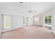Spacious bedroom with carpet flooring, ceiling fan, and sliding glass doors to the pool at 18112 Windswept Av, Port Charlotte, FL 33948