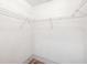 Empty walk-in closet features white wire shelves and neutral walls at 18112 Windswept Av, Port Charlotte, FL 33948
