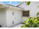 Exterior shot of a white building with a double door and a window at 18112 Windswept Av, Port Charlotte, FL 33948