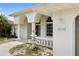 Exterior of a home with white stucco, arched entry, fountain and two-car garage at 18112 Windswept Av, Port Charlotte, FL 33948