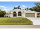 Charming single Gathering home featuring a manicured lawn and arched entryways to enhance curb appeal at 18112 Windswept Av, Port Charlotte, FL 33948