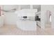 Open-concept kitchen with an island, white cabinets, and tile floors at 18112 Windswept Av, Port Charlotte, FL 33948