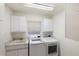 Convenient laundry room with washer, dryer, utility sink, and ample cabinet space for storage at 18112 Windswept Av, Port Charlotte, FL 33948