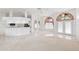 Open-concept living area features tile and carpet flooring and great natural light at 18112 Windswept Av, Port Charlotte, FL 33948