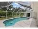 Enjoy the expansive screened-in pool area, perfect for outdoor activities and relaxation by the water at 18112 Windswept Av, Port Charlotte, FL 33948