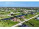 Aerial view of neighborhood featuring homes along a canal at 204 W Pine Valley Ln, Rotonda West, FL 33947