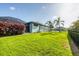 Large grassy backyard with an iron fence and a screened-in lanai at 204 W Pine Valley Ln, Rotonda West, FL 33947