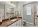 Bathroom with walk-in shower, granite topped vanity, and an adjacent window at 204 W Pine Valley Ln, Rotonda West, FL 33947