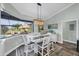 Dining area with views of screened-in lanai and pool, featuring a table with seating for four at 204 W Pine Valley Ln, Rotonda West, FL 33947